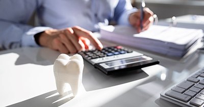 Dentist calculating how to make cosmetic dentistry affordable in Grafton