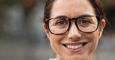 Woman smiling with dental bridge in Grafton