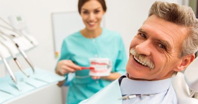 man smiling while visiting dentist 
