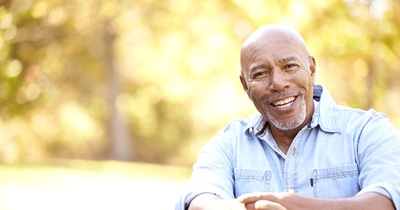 Man outside smiles with dentures in Grafton