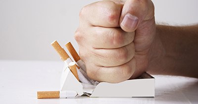 Man crushing cigarettes