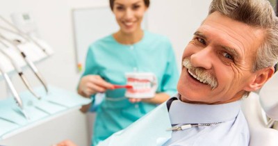 Smiling senior man in dental chair