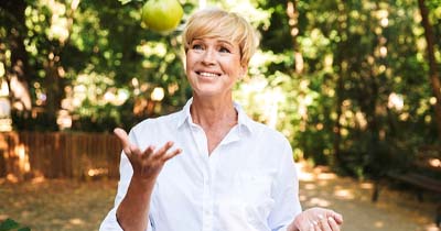 Woman throwing an apple into the air