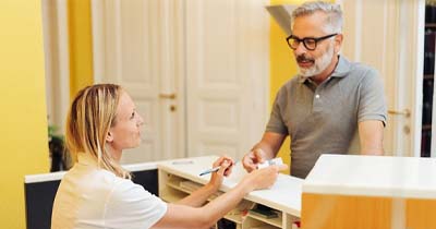 Patient shaking hands with a dentist in Grafton