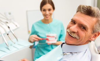 Smiling senior man in dental chair