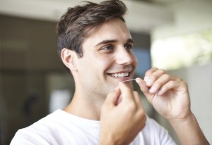 Man flossing his teeth