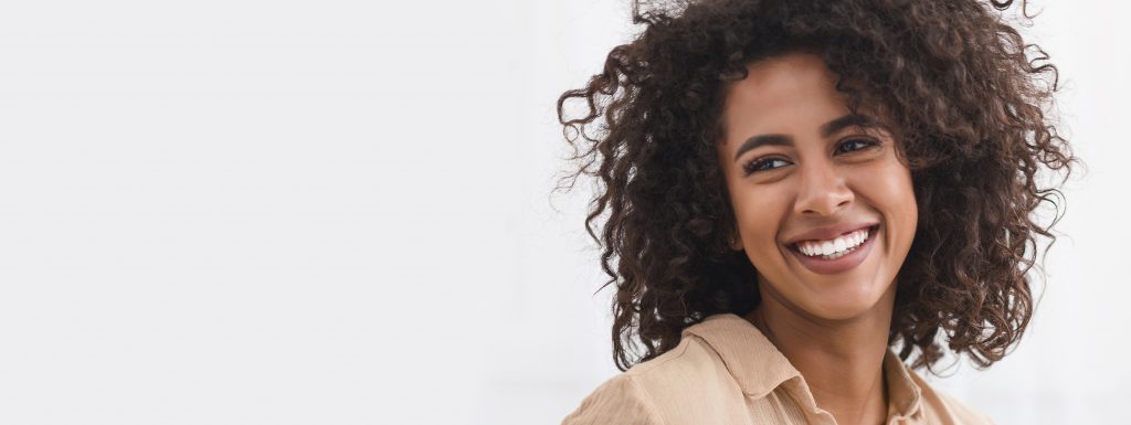 young attractive woman smiling after receiving dental crown in grafton