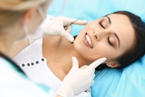 Woman at dentist learning the difference between veneers and bonding. 