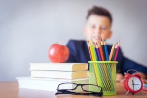 School items on a boy’s desk