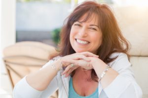 Middle-aged woman smiling after cosmetic dentistry