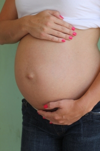 Pregnant woman with hands on belly